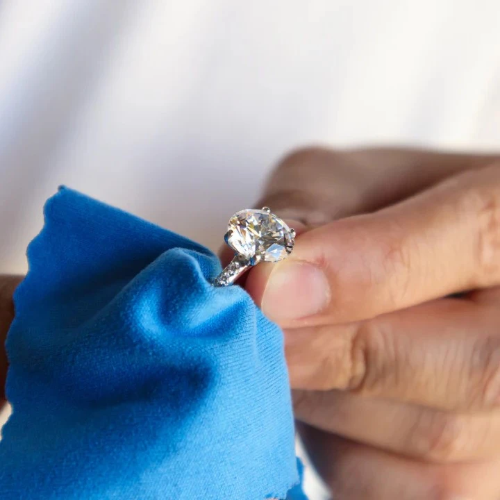 Diamond being cleaned and measured accurately as part of the diamond guide process for ring sizing